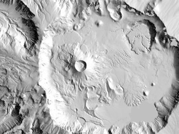 Black and white photograph of an impact crater and terrain on solid landmass